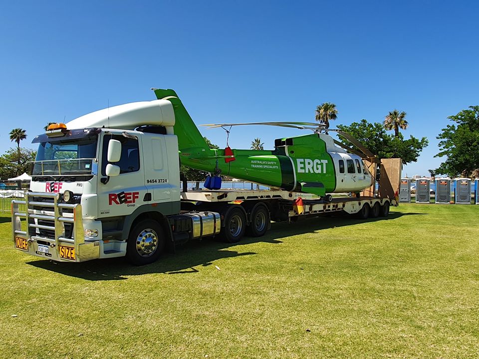 One of Reef Group's Hiab Trucks in Bunbury transporting a helicopter.