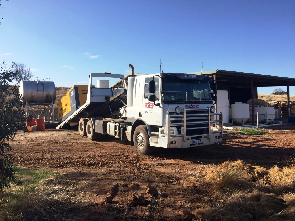 Tilt tray off loading a container
